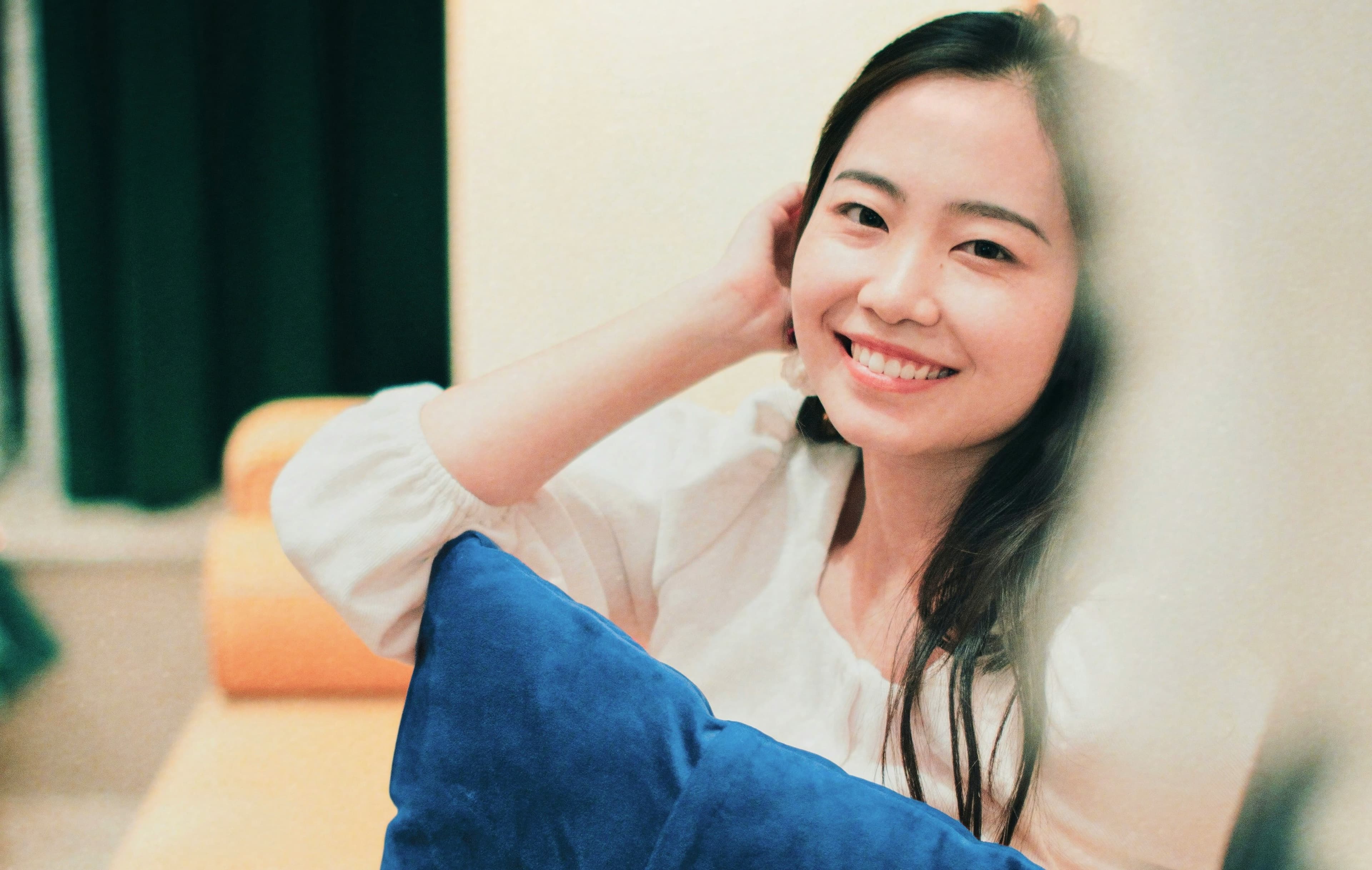 Woman smiling warmly in a comfortable setting